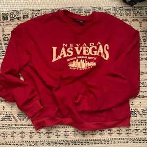 Shein red sweatshirt with graphics in the front